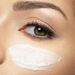 cosmetic cream spread below eye
